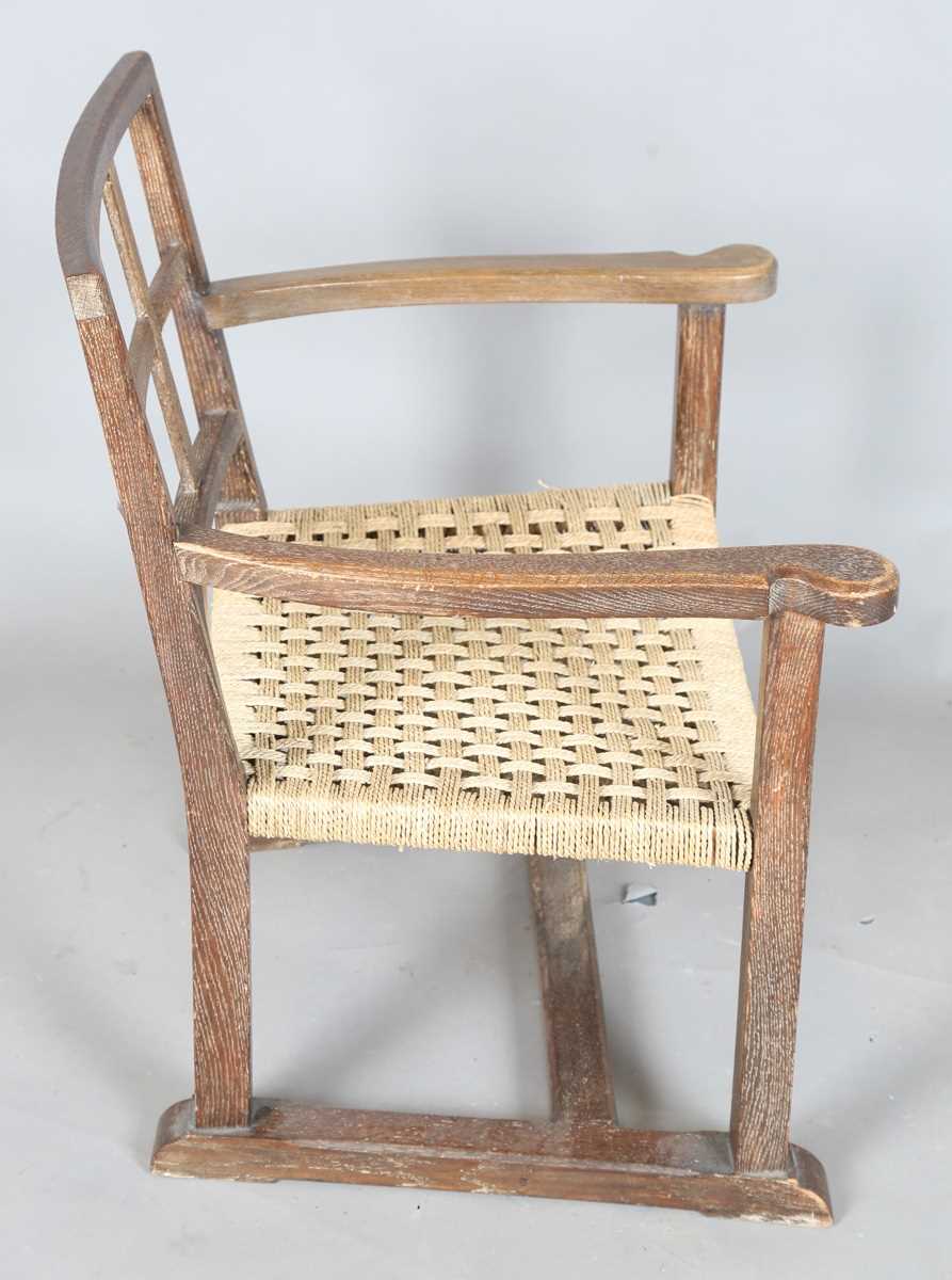 An early 20th century Cotswold School limed oak low elbow chair with woven string seat, height 70cm, - Image 6 of 10