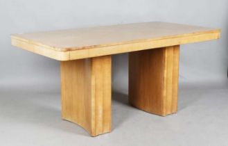 An Art Deco pale walnut centre table, the rectangular top above shaped block supports, height