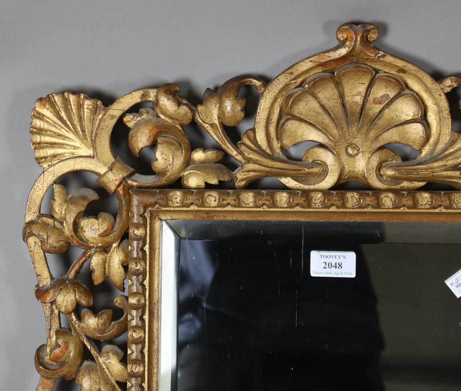 An early 20th century Continental giltwood wall mirror with a carved foliate frame and bevelled - Image 2 of 9