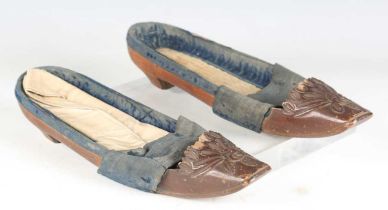 A pair of late 18th/early 19th century French walnut lady's shoes, the fronts finely carved with a