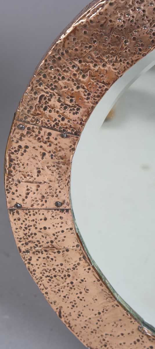 An early 20th century Arts and Crafts hammered copper oval wall mirror with riveted panels and - Image 2 of 6