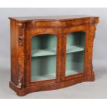 A mid-Victorian burr walnut serpentine fronted glazed bookcase with projecting corners, height 91cm,