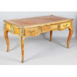 A 20th century French kingwood and gilt metal mounted bureau plat, the top inset with gilt-tooled