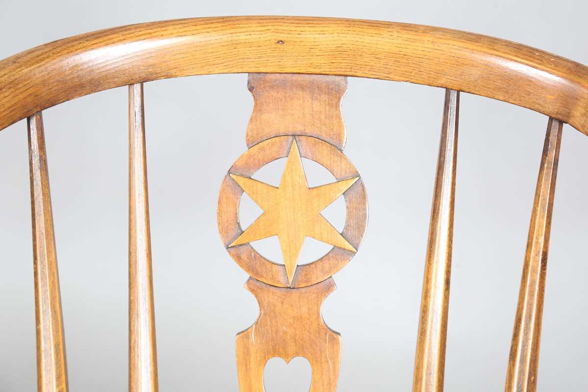 An early 20th century Arts and Crafts ash and elm tub back armchair with a pierced star splat - Image 3 of 9