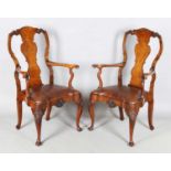 A pair of early 20th century Queen Anne style walnut vase back elbow chairs with brown leather