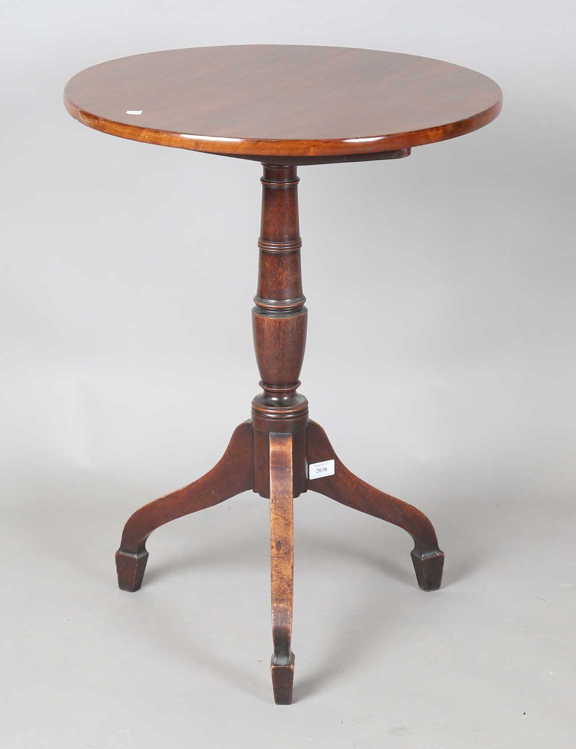 A George III mahogany circular tip-top wine table, raised on tripod legs, height 73cm, diameter