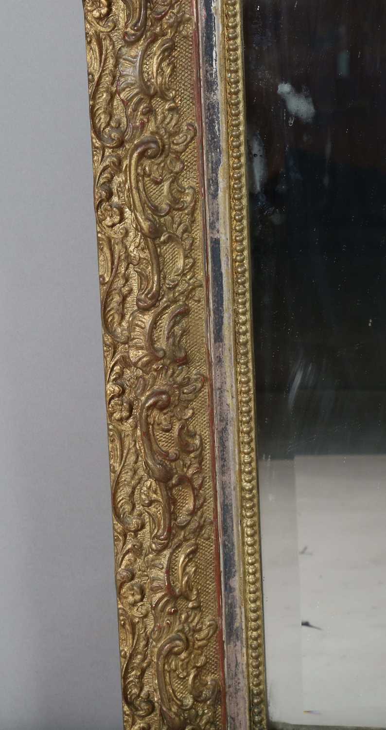 A late 19th century gilt composition arched overmantel mirror with a foliate scroll surmount and - Image 10 of 15