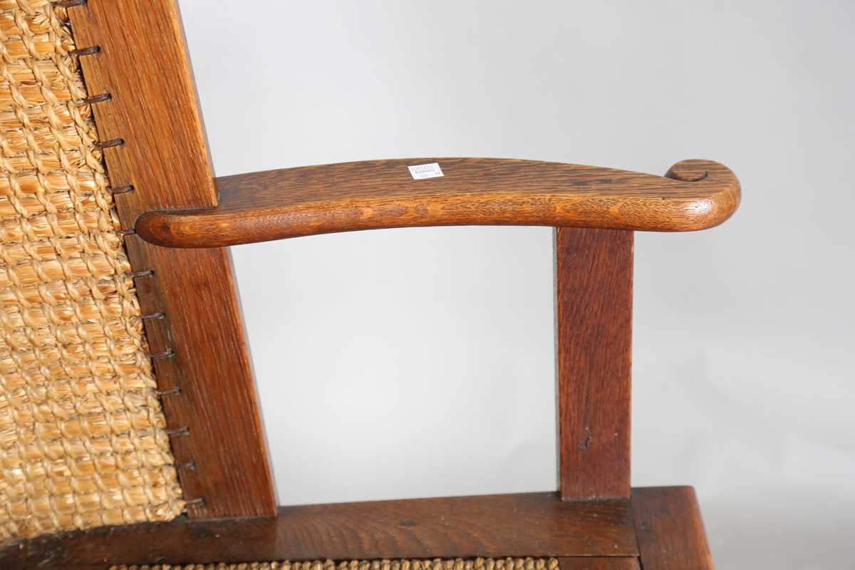 An early 20th century oak framed Orkney armchair, the curved woven straw back and string seat raised - Image 8 of 14