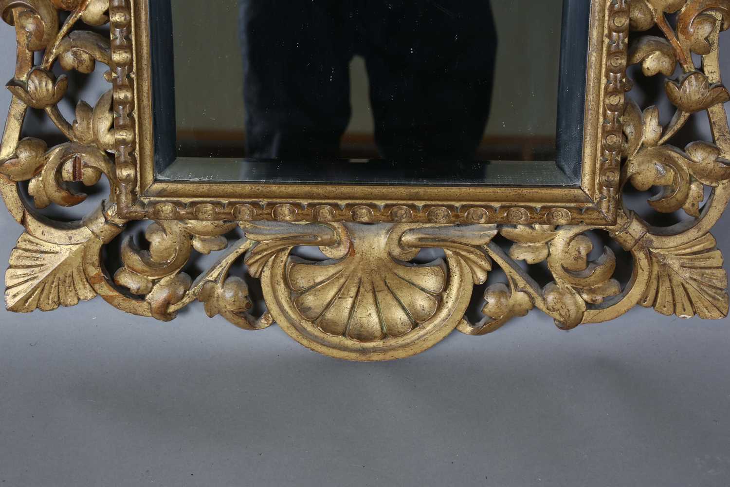 An early 20th century Continental giltwood wall mirror with a carved foliate frame and bevelled - Image 6 of 9