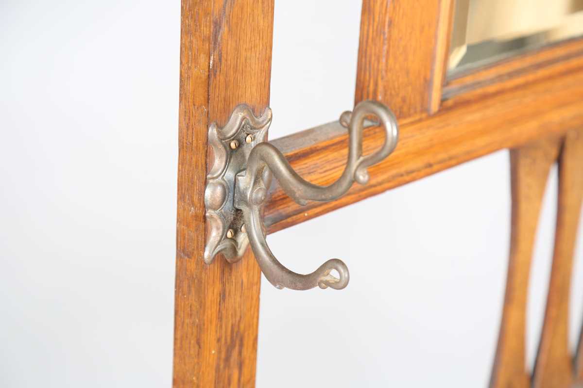 An Edwardian Arts and Crafts oak hallstand, the pediment pierced with stylized tulips, height - Image 7 of 15