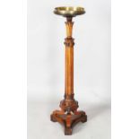 A William IV mahogany torchère, the top fitted with a brass tray above a reeded stem and triform