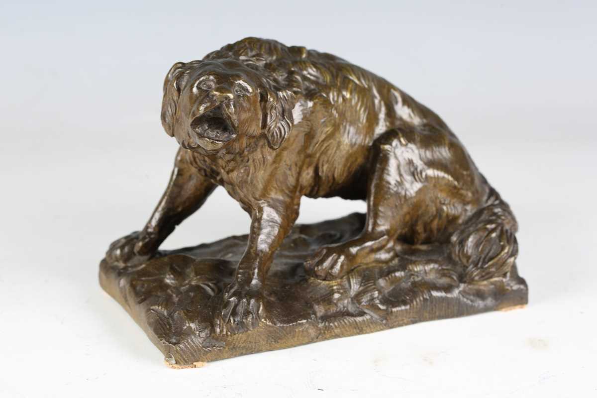 A late 19th century Continental green patinated cast bronze model of a barking dog, raised on a