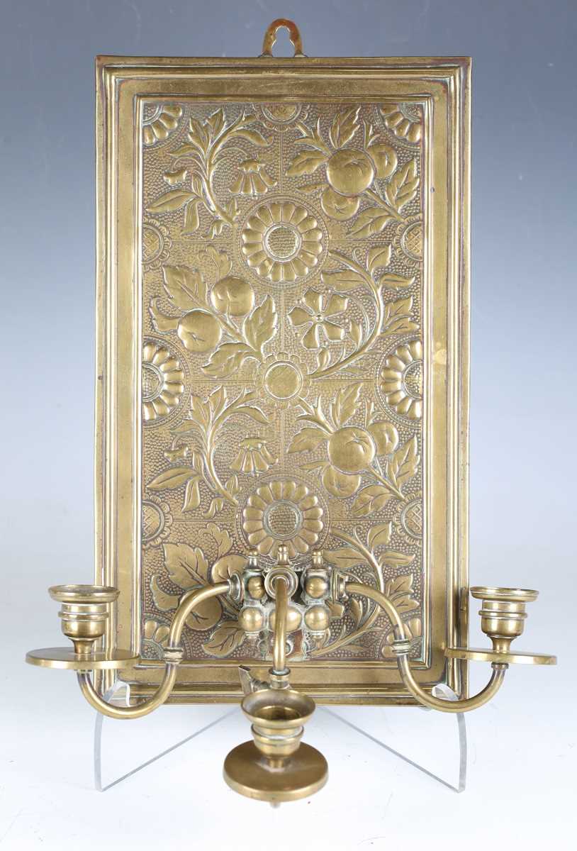 A late Victorian Aesthetic Movement brass three-light wall sconce, in the manner of Bruce Talbert,