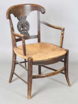 A late 19th century Arts and Crafts stained beech framed armchair, in the manner of Morris & Co, the