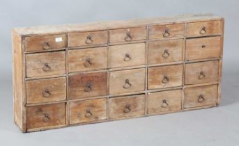A 19th century pine bank of twenty drawers, height 59cm, width 132cm, depth 20cm. Provenance: from