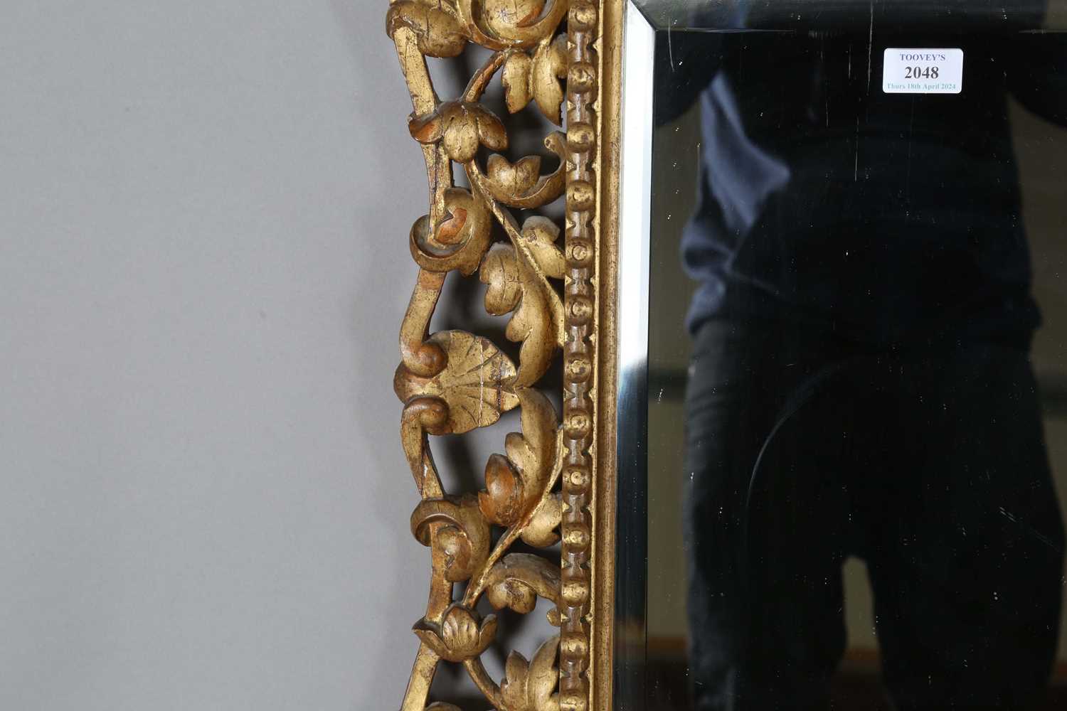 An early 20th century Continental giltwood wall mirror with a carved foliate frame and bevelled - Image 8 of 9