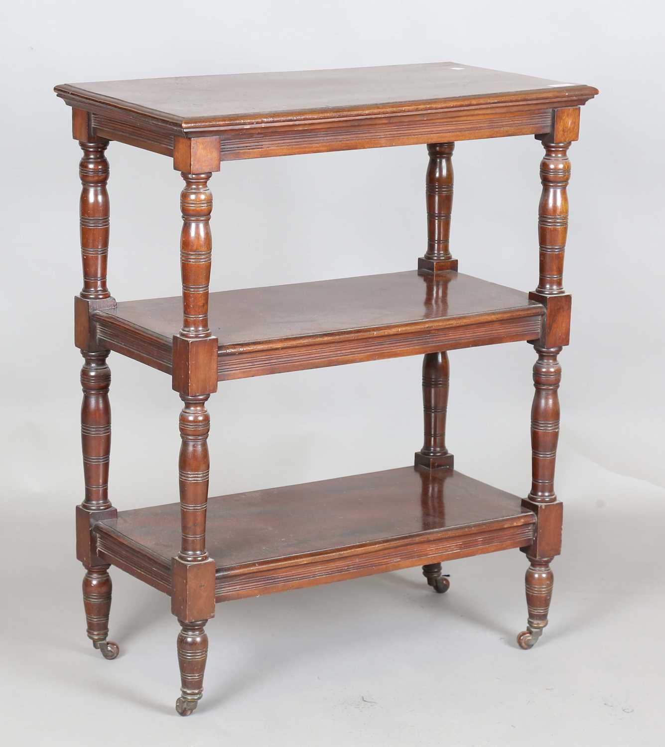 A late Victorian mahogany three-tier whatnot with ring turned legs and castors, height 92cm, width