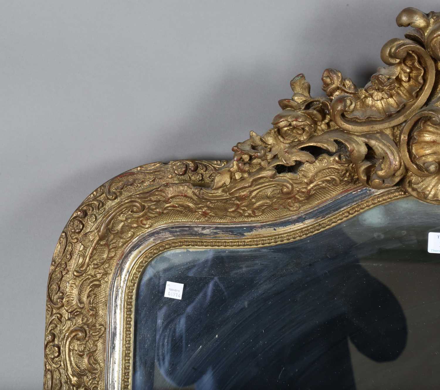 A late 19th century gilt composition arched overmantel mirror with a foliate scroll surmount and - Image 2 of 15
