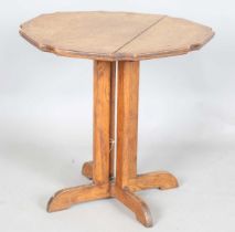 An early 20th century Arts and Crafts Cotswold School circular occasional table, the shaped top on