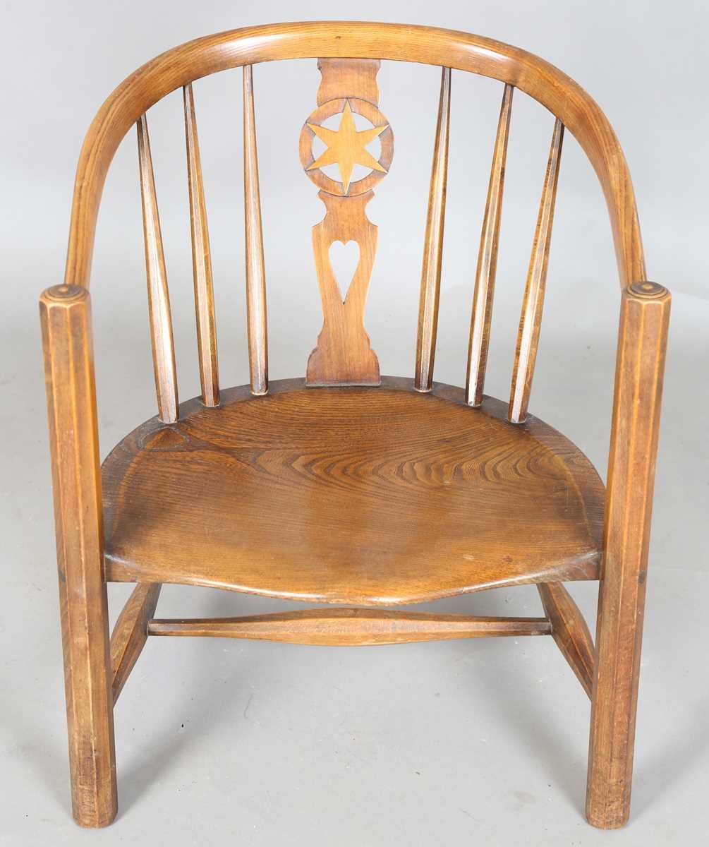 An early 20th century Arts and Crafts ash and elm tub back armchair with a pierced star splat - Image 2 of 9