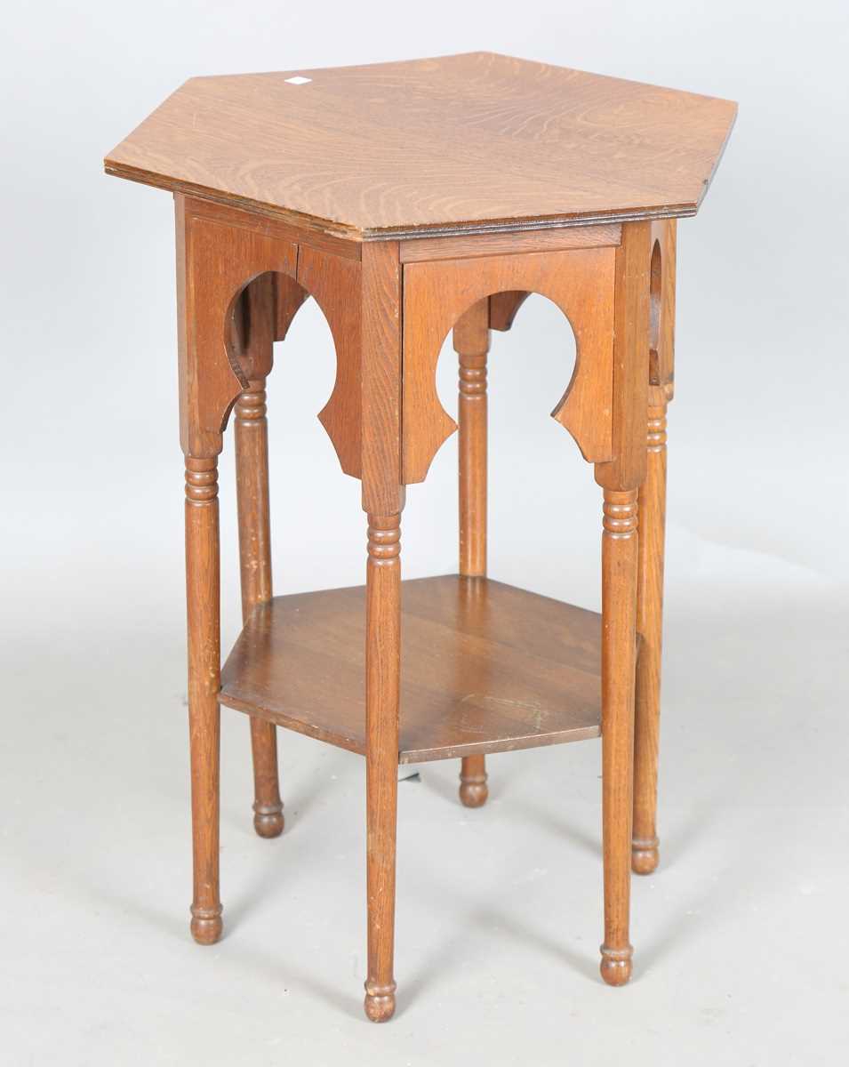 An Edwardian Arts and Crafts oak hexagonal occasional table, possibly by Liberty & Co, the Moorish