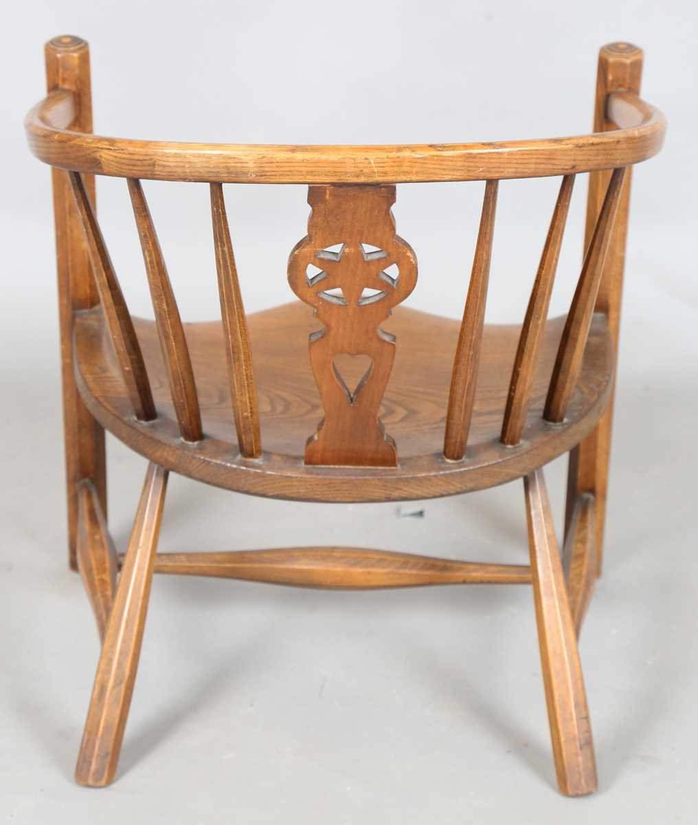 An early 20th century Arts and Crafts ash and elm tub back armchair with a pierced star splat - Image 7 of 9
