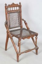 A late 19th century American Arts and Crafts walnut framed side chair by George Hunzinger, the