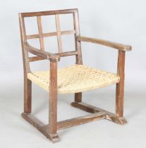 An early 20th century Cotswold School limed oak low elbow chair with woven string seat, height 70cm,