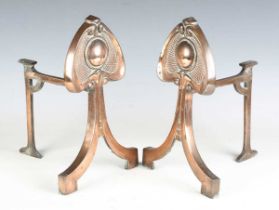 A pair of Art Nouveau coppered fire andirons of stylized tulip form, height 31cm.