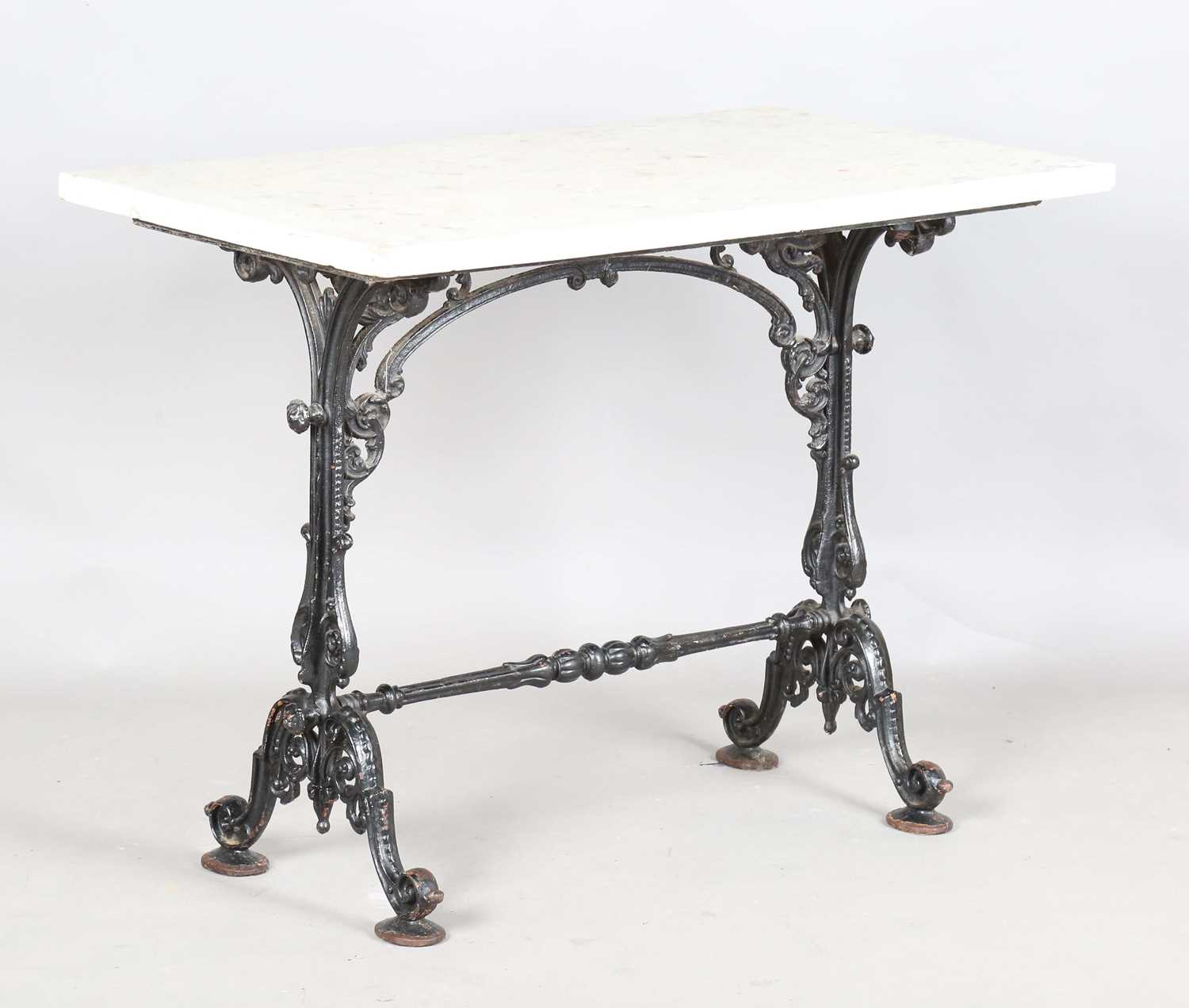 A late 19th century cast iron bistro table with a rectangular white marble top, height 76cm,