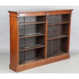 An Edwardian mahogany two-section open bookcase, on a plinth base, height 117cm, width 154cm,