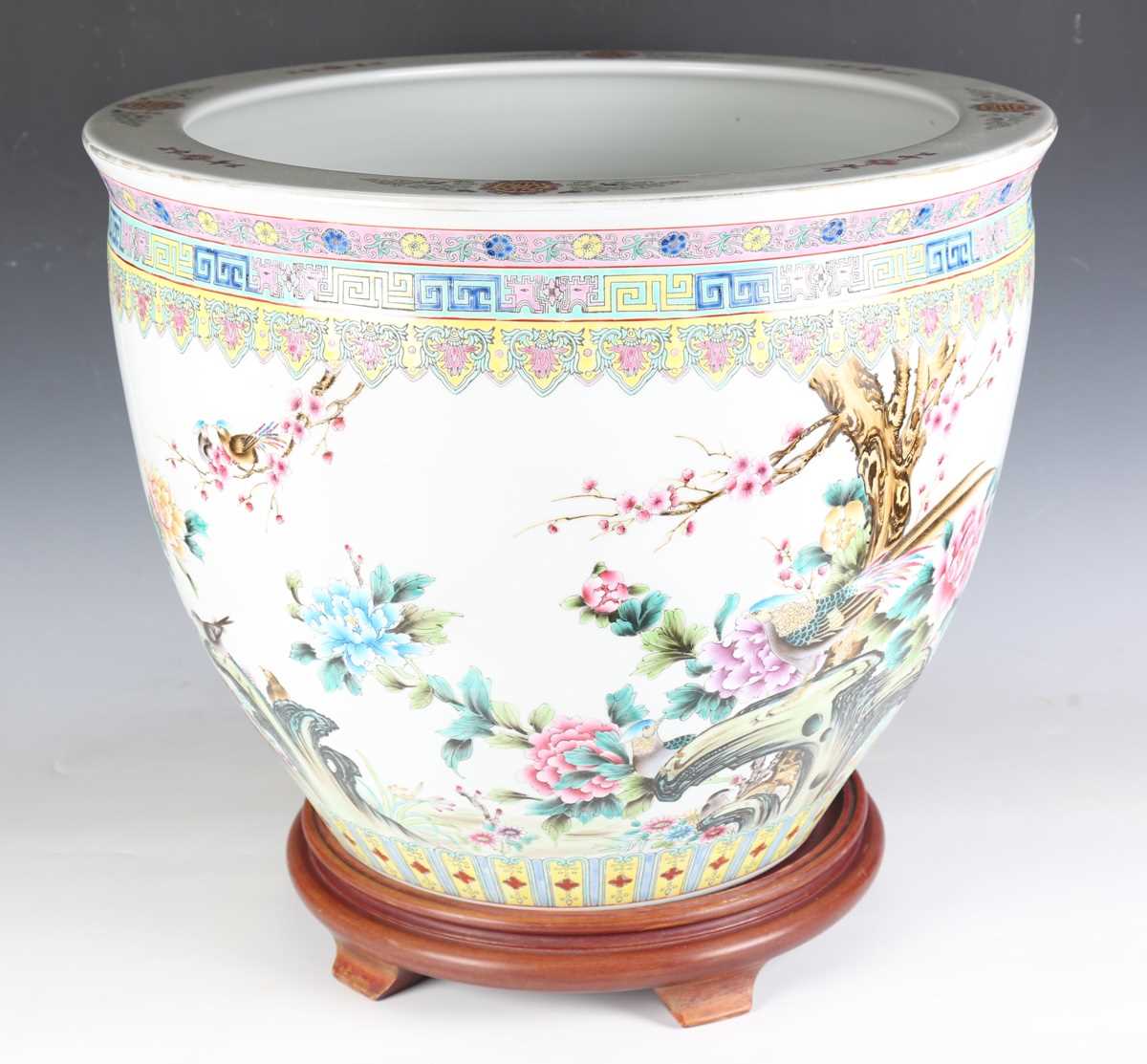 A large Chinese porcelain jardinière stand, painted with birds and flowers, height 44cm, diameter