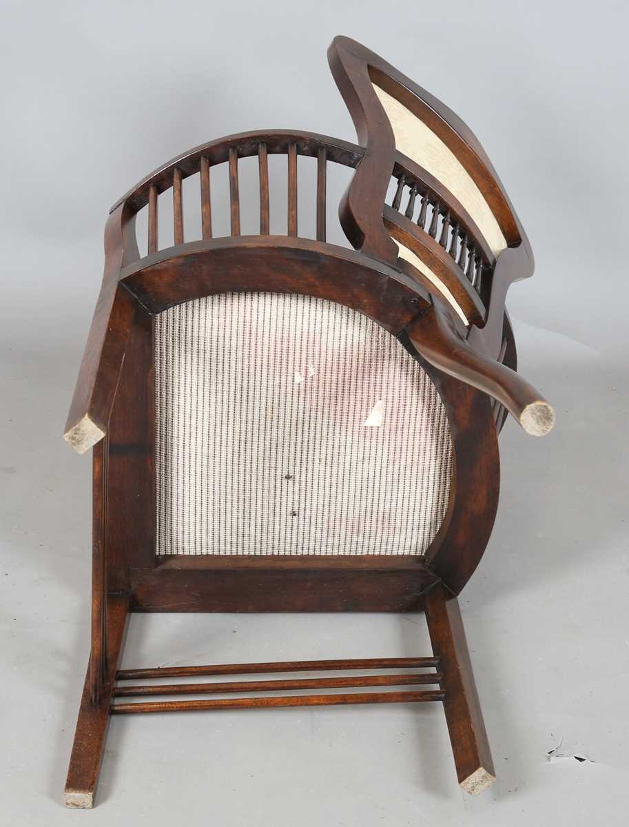 An Edwardian Arts and Crafts style stained walnut showframe armchair, upholstered in cream fabric, - Image 17 of 17