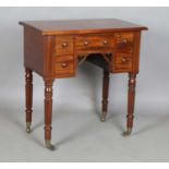 A small Victorian mahogany side table, the five frieze drawers above reeded legs and brass
