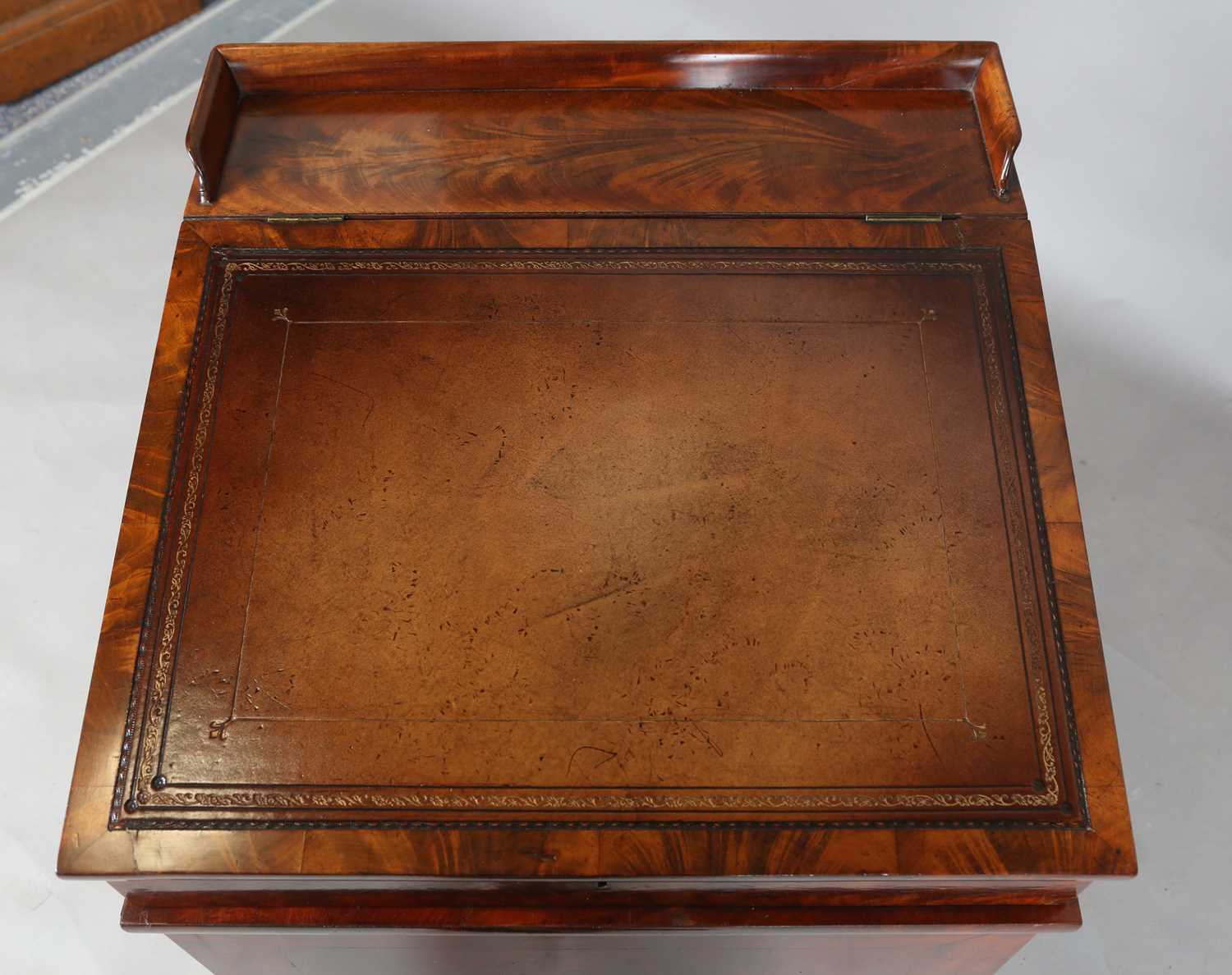 A good early Victorian flame mahogany Davenport, the hinged writing slope inset with tooled - Image 2 of 12