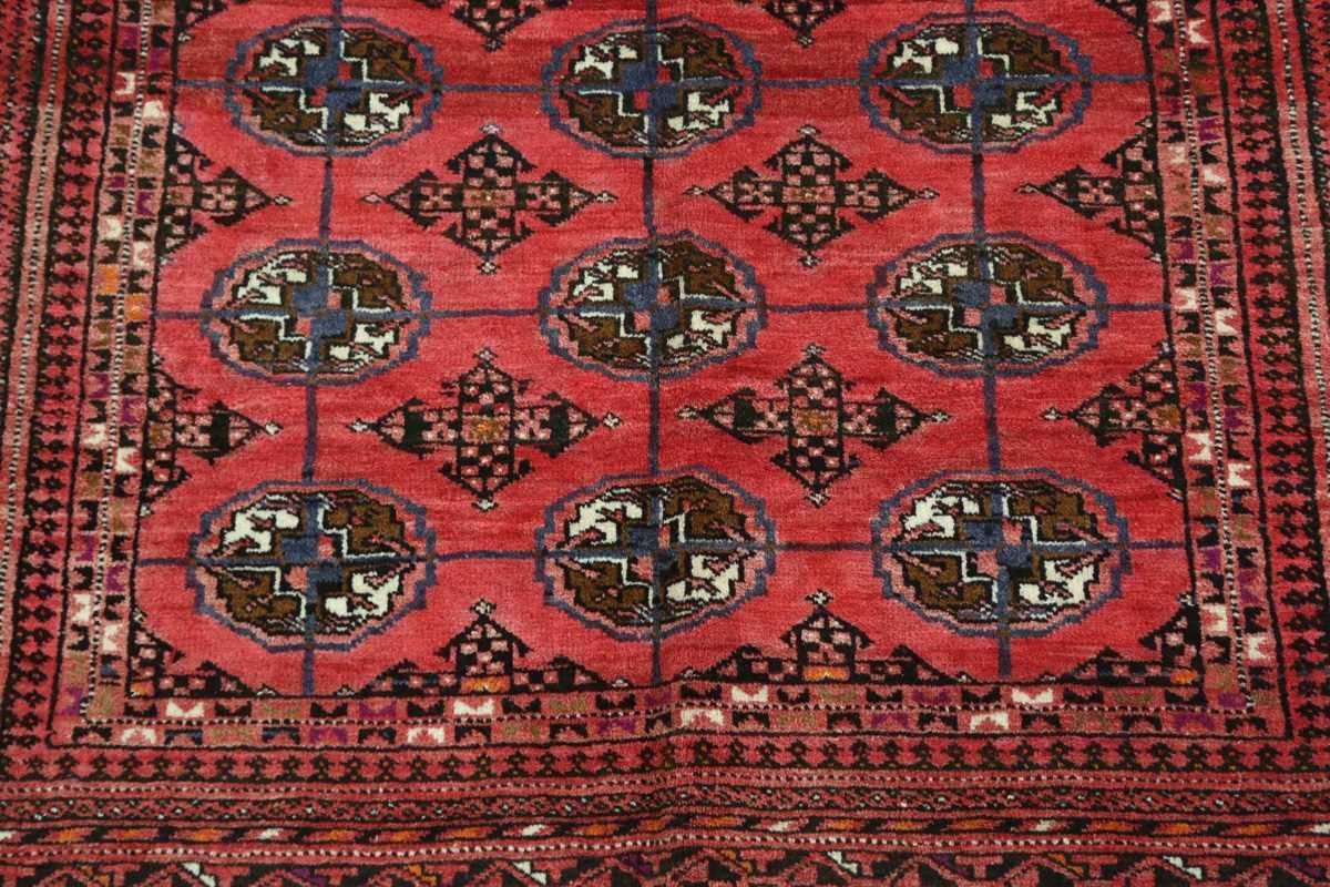 A Turkestan rug, late 20th century, the pale claret field with three columns of guls, within a - Image 4 of 7