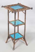 A late Victorian Aesthetic Movement bamboo three-tier table, inset with three turquoise glazed tiles