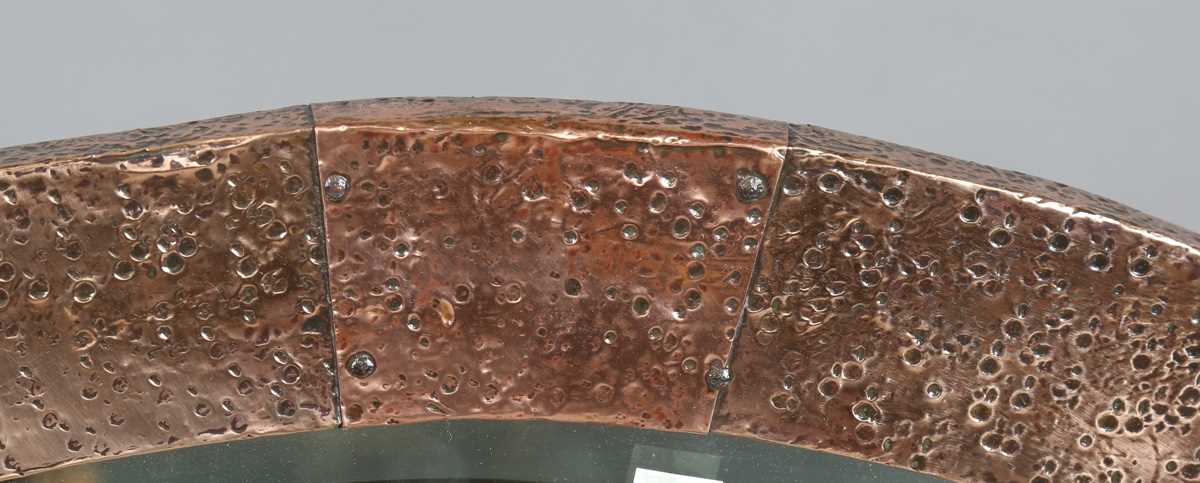 An early 20th century Arts and Crafts hammered copper oval wall mirror with riveted panels and - Image 5 of 6