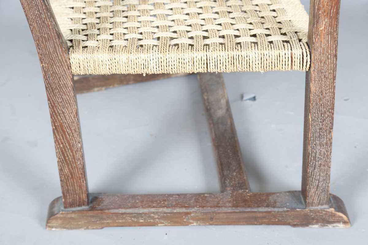 An early 20th century Cotswold School limed oak low elbow chair with woven string seat, height 70cm, - Image 8 of 10