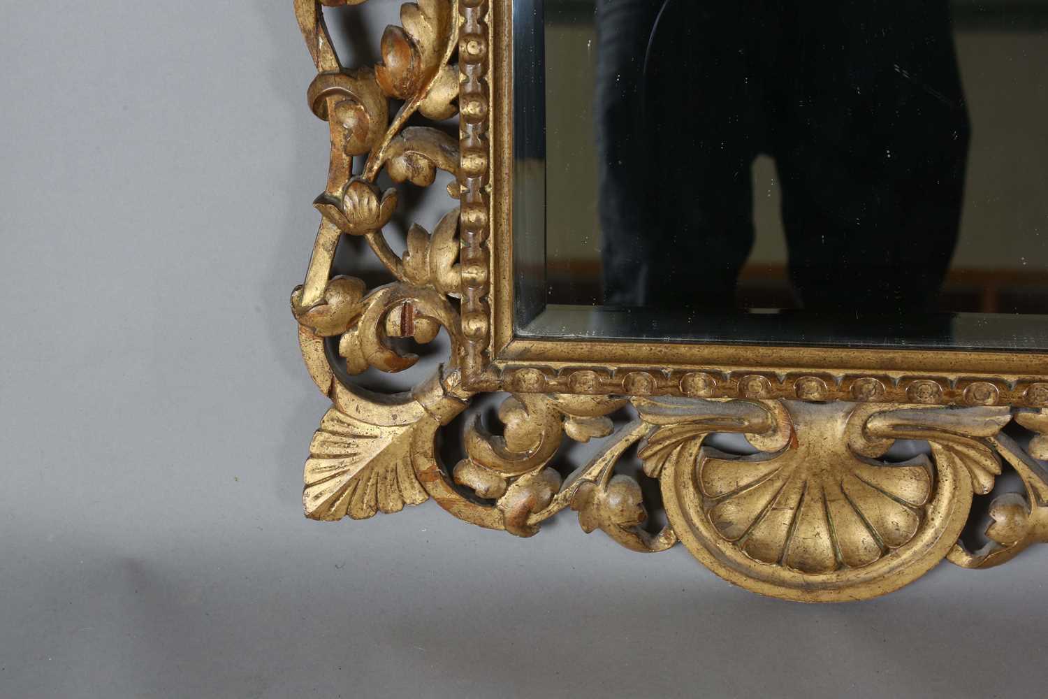 An early 20th century Continental giltwood wall mirror with a carved foliate frame and bevelled - Image 7 of 9