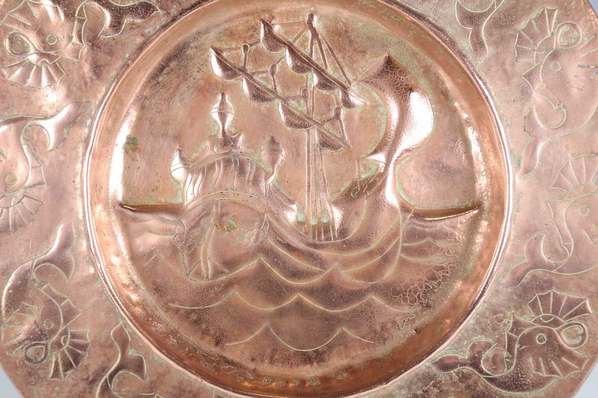 A Newlyn style copper circular charger, worked with a central galleon within a border of fish, - Image 2 of 7