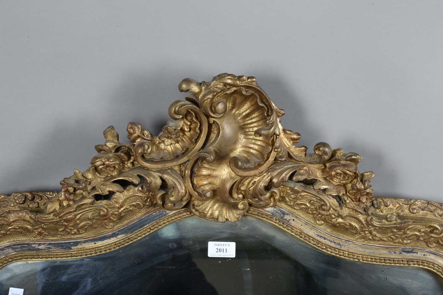 A late 19th century gilt composition arched overmantel mirror with a foliate scroll surmount and - Image 3 of 15