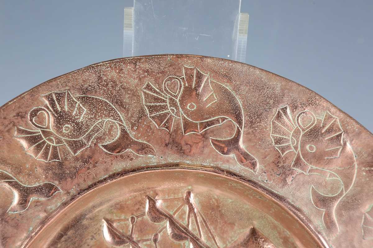 A Newlyn style copper circular charger, worked with a central galleon within a border of fish, - Image 3 of 7