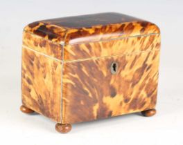 A Regency tortoiseshell tea caddy with white metal stringing and turned bun feet, width 13cm.