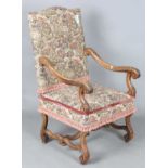 A late 19th century French Baroque Revival walnut framed armchair, upholstered in machined tapestry,
