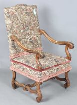 A late 19th century French Baroque Revival walnut framed armchair, upholstered in machined tapestry,