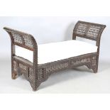 An early 20th century Middle Eastern softwood daybed, similar to those retailed by Liberty & Co,