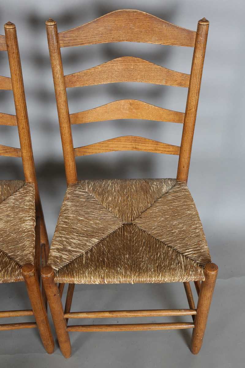 A set of six early 20th century Arts and Crafts ash framed ladder back chairs, in the manner of - Image 11 of 15