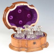 A mid-19th century French satin walnut scent bottle box, the serpentine form with a carved cruciform