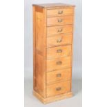 A late Victorian pine narrow chest of eight drawers, height 125cm, width 44cm, depth 33cm,